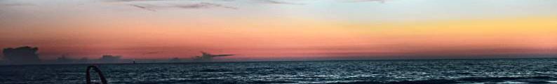 A person stretching at a beach in the evening